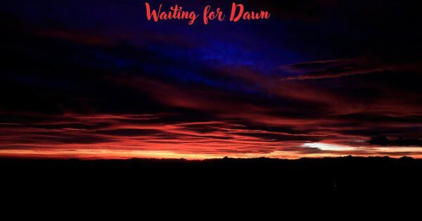 dawn breaking through a night sky