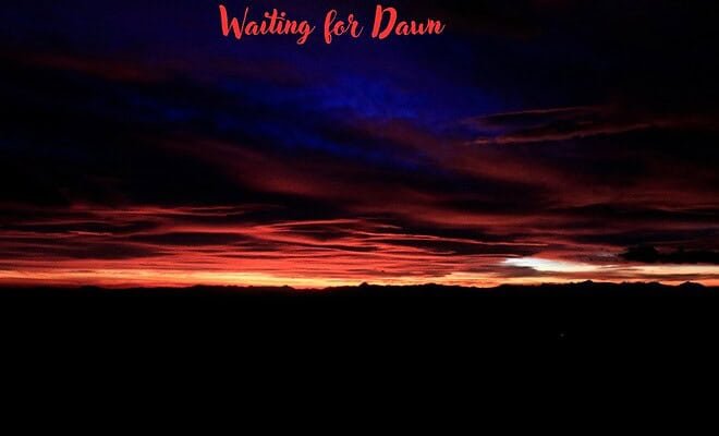 dawn breaking through a night sky