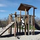 a playground structure in a park with a blue sky background