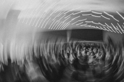 A party in gray scale spins in a circle, drawing the lights in a spiral.
