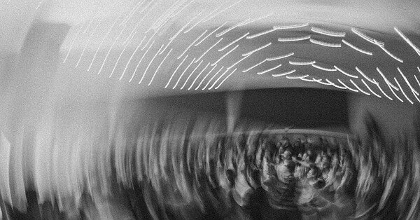 A party in gray scale spins in a circle, drawing the lights in a spiral.