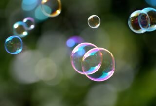 Bubbles with reflecting colorful light floating.