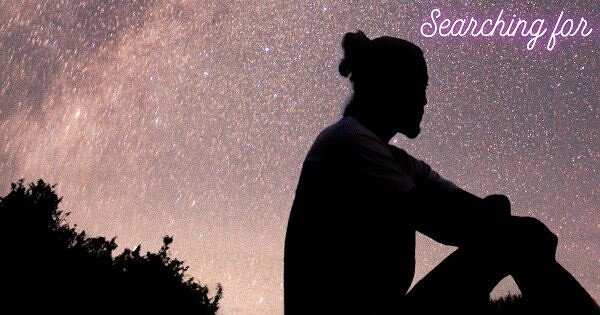 person sitting watching the night sky