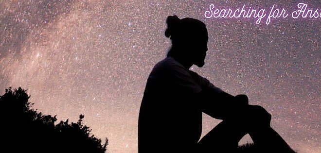 person sitting watching the night sky