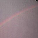 Image of a rainbow in the sky after a rainstorm