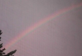Image of a rainbow in the sky after a rainstorm