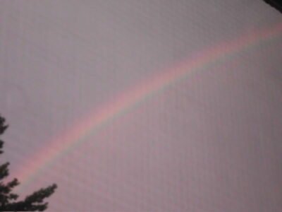 Image of a rainbow in the sky after a rainstorm