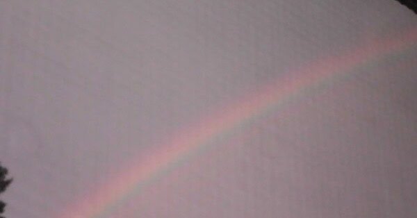 Image of a rainbow in the sky after a rainstorm