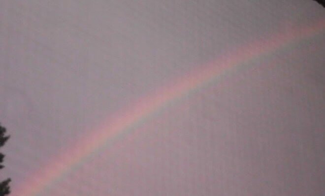 Image of a rainbow in the sky after a rainstorm