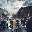 women gathered in the street with buildings around them