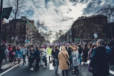women gathered in the street with buildings around them