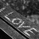 A black and white background with the words "I love" etched into a piece of wood.