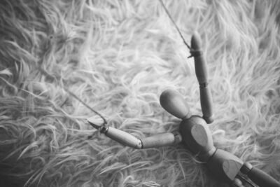 wooden puppet on string