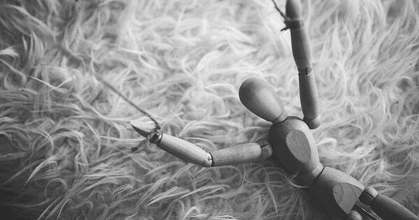 wooden puppet on string