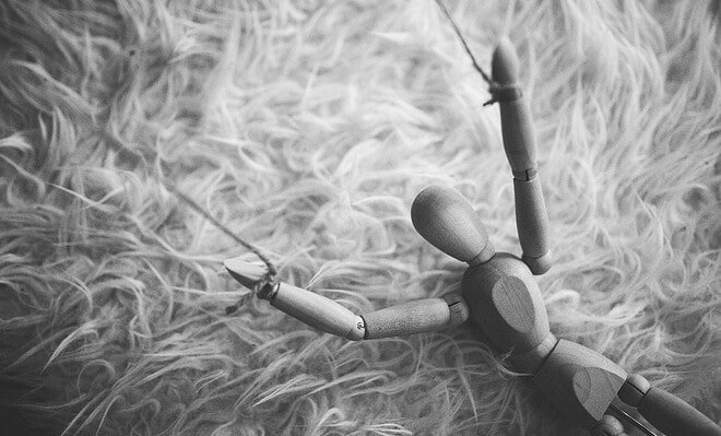 wooden puppet on string