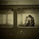 A woman crying in a train compartment car